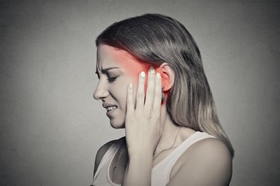 Woman experiencing a dental emergency in New York City