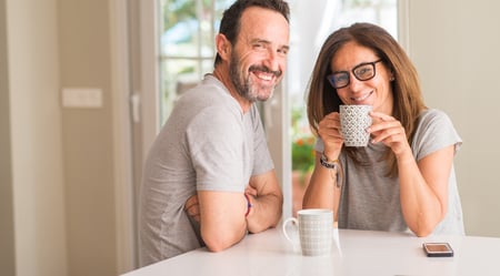Middle Aged Couple Smiling and Drinking Coffee