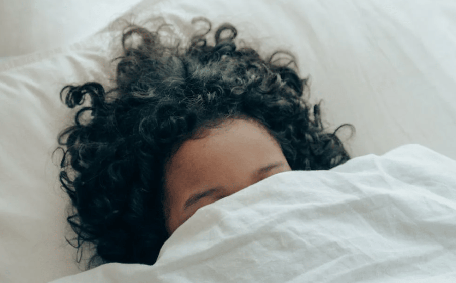 In bed, having a nightmare